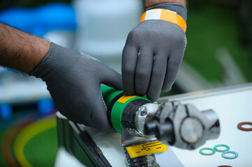 Plumber hands in gloves cut plastic pipes with the polyfusion welding machine