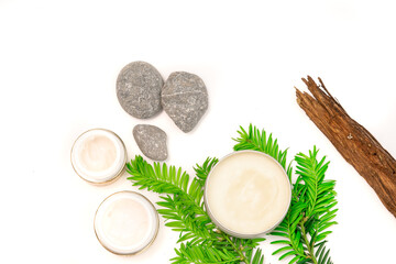 face care cosmetics and natural elements on green white background