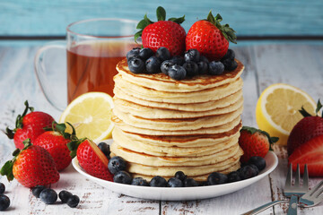 A stack if home-made pancakes with berry