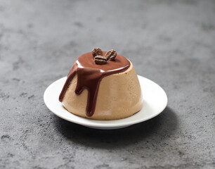 Italian dessert Panna Cotta creamy coffee with chocolate on a plate on a dark gray background