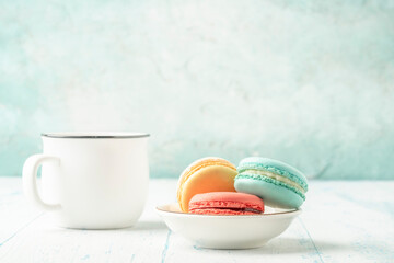 colorful macaroons and coffee on wooden table with copy space