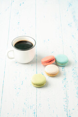 colorful macaroons and coffee on wooden table with copy space