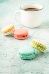 colorful macaroons and coffee on a table