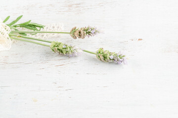 lavender flowers on a wooden background decorated with ribbon