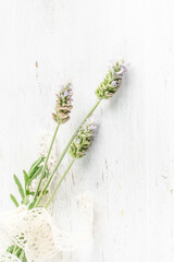 lavender flowers on a wooden background decorated with ribbon