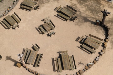 empty benches and a table in the garden