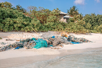 Stranded fishing nets and garbage. The concept of ocean pollution-negative impact on the ecological...