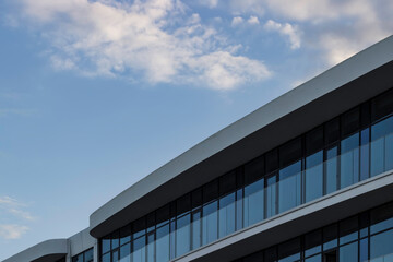 Fototapeta na wymiar Part of a modern glass building on a background of blue sky.