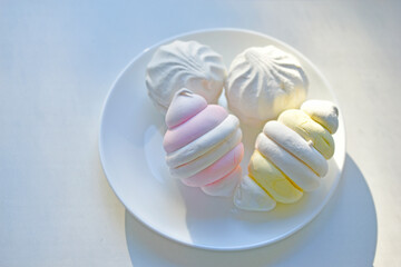 Fototapeta na wymiar Colorful delicious marshmallows on a white plate