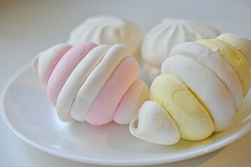 Fototapeta na wymiar Colorful delicious marshmallows on a white plate