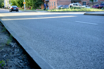 Fototapeta na wymiar Asphalt surface and street in the city in summer