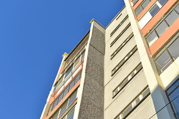 The wall of the yellow new house in the summer in the sun