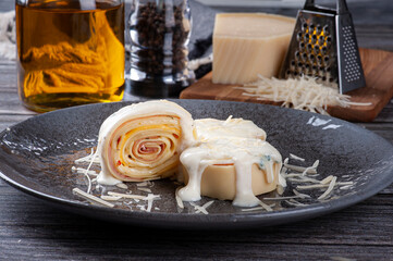 .Ham and cheese rondelli topped with white parmesan sauce