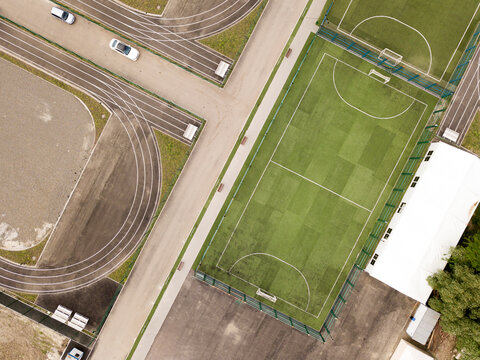 Aerial top down drone photo of green football pitch empty to be used for soccer game. Russia. Rostov-on-Don.