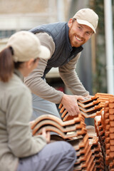 bricklaying construction worker building a brick wall