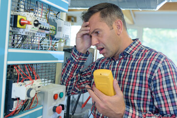 a man is fixing a voltage problem