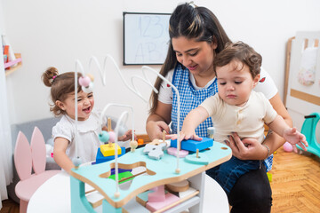 Female teacher teaching little students