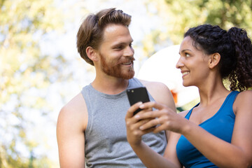 two runners checking achievements on mobile phone app