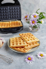 The process of making belgian waffles.