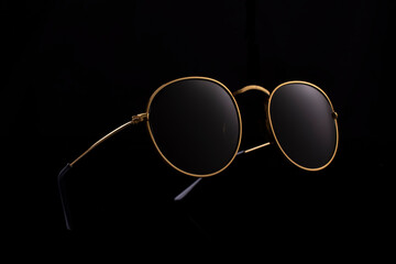 round glasses on black background, advertising photo