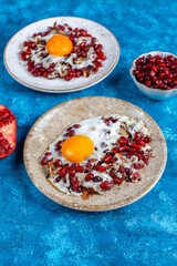 Traditional Azerbaijan cuisine pomegranate seeds with egg narnumru or nar numru.