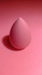 Cosmetic Makeup Sponge,pink backround.Focus on the sponge.