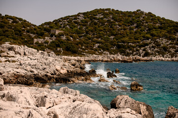 beautiful view of the rocky sea coast and clear turquoise water and sea waves