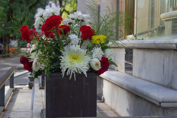 Flower arrangement with red, white and yellow flowers.