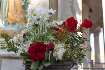 Flower arrangement with red, white and yellow flowers.
