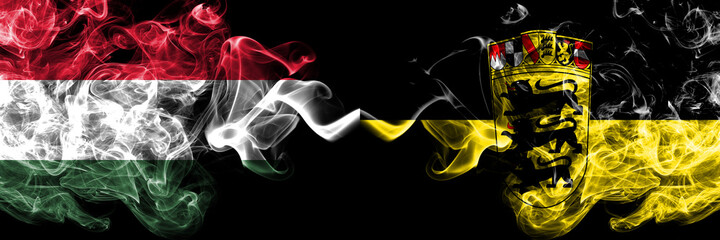 Hungary, Hungarian vs Germany, German, Deutschland, Baden Wurttemberg smoky flags side by side.