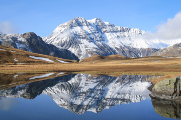 Amazing reflections in lake Plan du Lac Bellecombe looking towards La Grande Casse in the French alps
