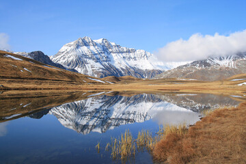 Obraz premium Amazing reflections in lake Plan du Lac Bellecombe looking towards La Grande Casse in the French alps 