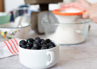 White bowl filled with blueberries.