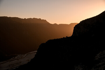 aerial view of the dark silhouettes of mountains at sunset