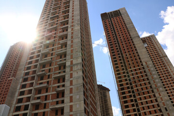Obraz premium selective focus Tall buildings and blue sky. turkey istanbul's new buildings under construction reaching the clouds