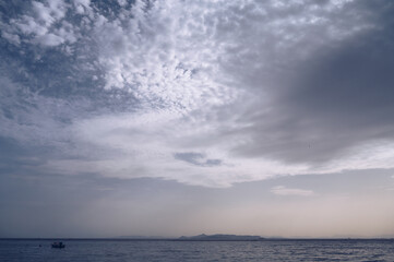 Beautiful landscape of Aegean sea in Athens at cloudy day. Lonely boat. Silhouettes of islands in the mist. Nobody. Greece.