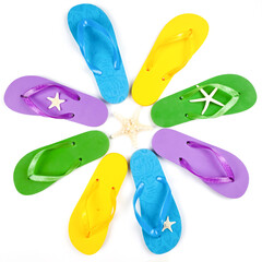 three pairs of beach rubber flip flops on a white background, view from above