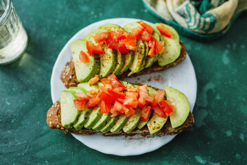 Tasty fresh toast with avocado and tomatoes