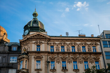 Fototapeta na wymiar Neo-renaissance style Stybl's house at Wenceslas Square, green copper dome with clock and small turret, CSOB bank building in sunny day, stone stucco, blue sky, Prague, Czech Republic