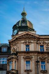 Fototapeta na wymiar Neo-renaissance style Stybl's house at Wenceslas Square, green copper dome with clock and small turret, CSOB bank building in sunny day, stone stucco, blue sky, Prague, Czech Republic