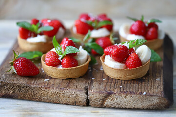 Delicious tartlets with strawberries and banana. Healthy summer dessert. Strawberry dessert.