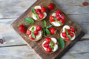 Delicious tartlets with strawberries and banana. Healthy summer dessert. Strawberry dessert.