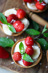 Delicious tartlets with strawberries and banana. Healthy summer dessert. Strawberry dessert.