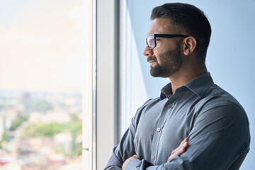 Headshot portrait of indian confident successful businessman in glasses thinking imagining future...