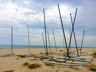 Sport sailboats stranded in the sand on a Winter's day in Rota beach, Cadiz, Andalusia, Spain