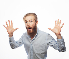 Fototapeta premium The young handsome bearded man in casual shirt got scared and hides behind his hands.