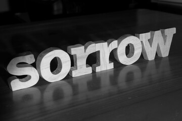 Sorrow, text words typography written with wooden letter on black background, life and business negativity
