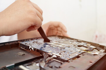 Close up of technician engineer trying to repairing broken laptop. Computer repairs and upgrade