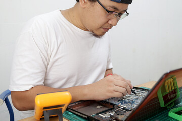 Close up of technician engineer trying to repairing broken laptop. Computer repairs and upgrade
