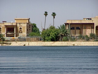 Buildings on the bank of a tributary of the Shatt Al-Arab River flowing through a Palace converted...